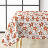 På bordet Flory Orange - Fin vaxduk med blommor i varma färger