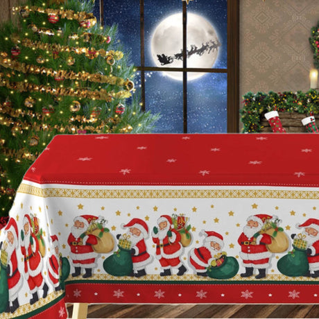 Jultomten med sin julklappsäck - En röd julvaxduk med en bård med fina jultomtar på bordet